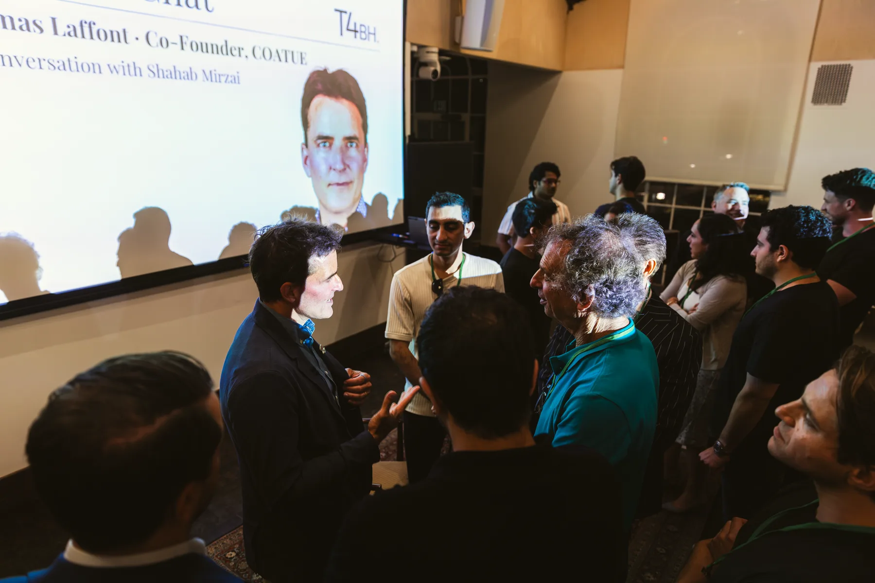 Thomas Laffont talking with attendees after the Fireside Chat